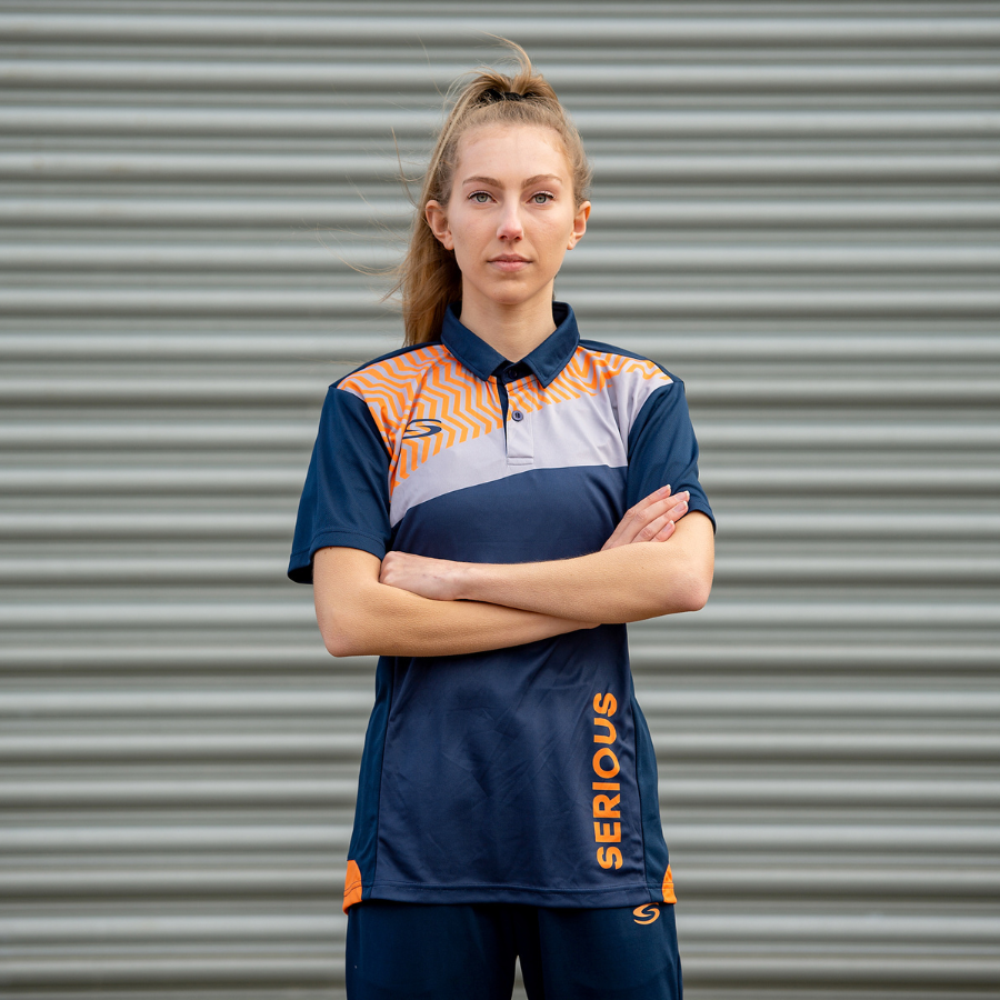 Pro Sublimation Teamwear Picture of Female wearing Navy/Orange Pro Sublimation Polo Shirt